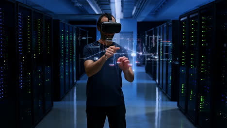 man in vr headset interacting with data in a server room