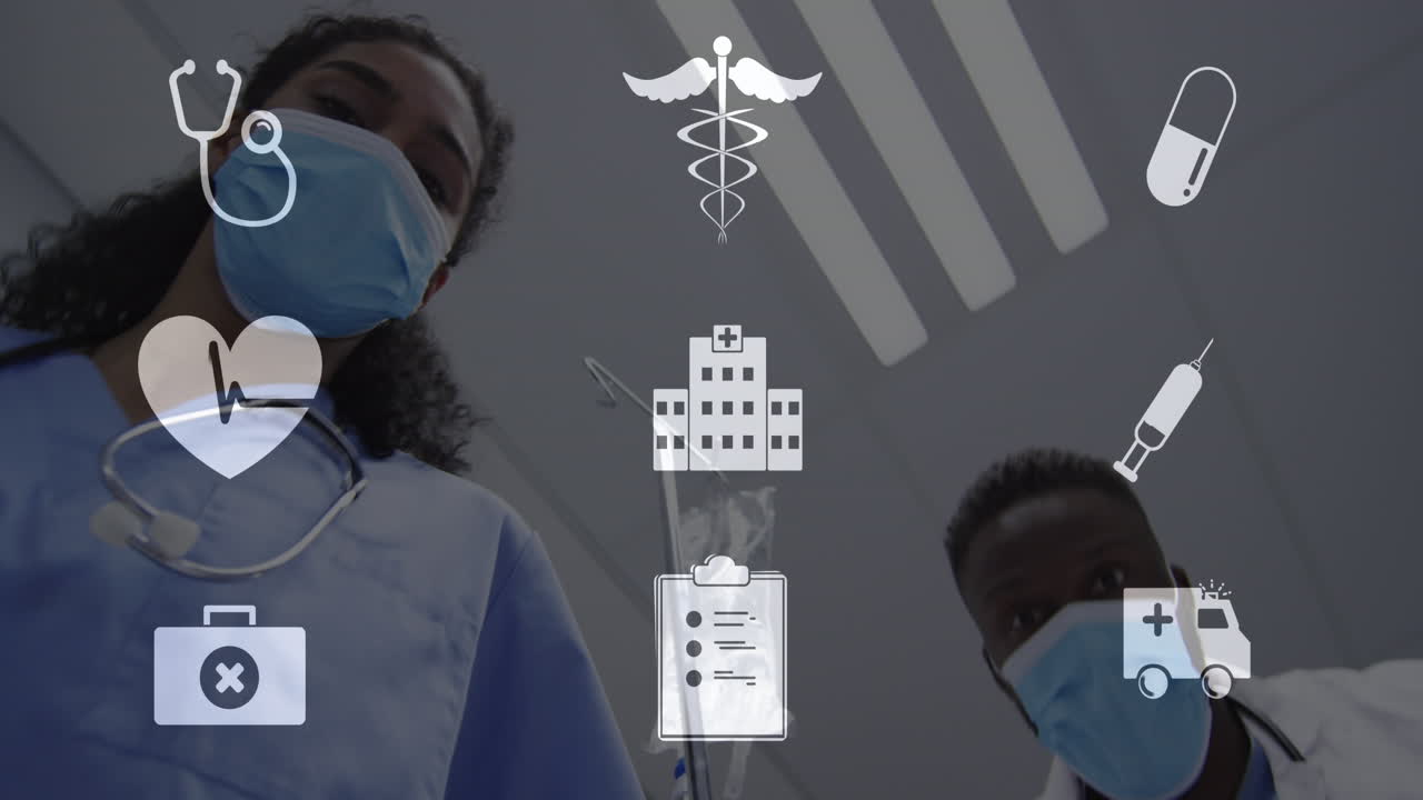 Animation of digital icons over diverse doctors in face masks in hospital