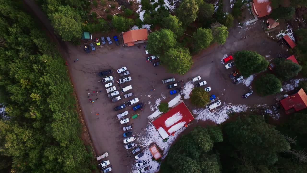 Campers And Parked Vehicles At La Joya Camping Ground In Nevado de Colima National Park, Mexico. aerial topdown shot