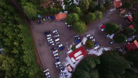 campers and parked vehicles at la joya camping ground in nevado de colima national park, mexico. aerial topdown shot