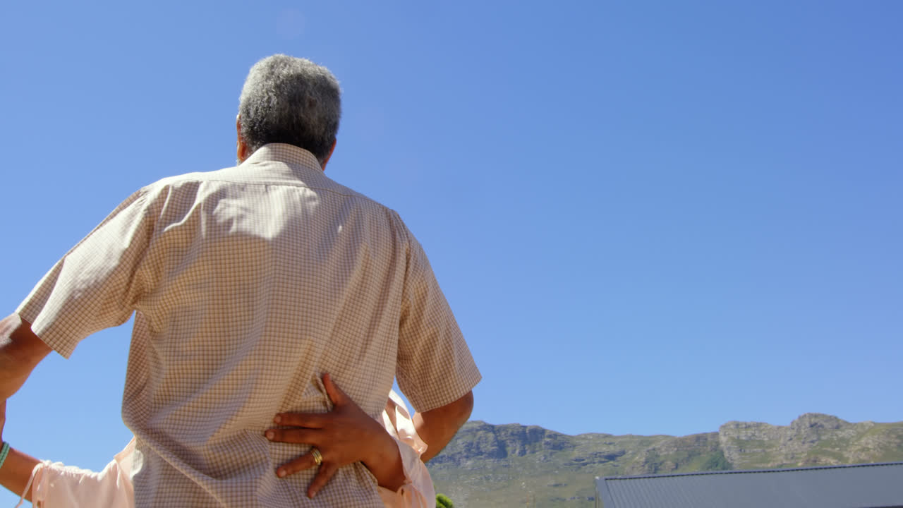 흑인 부부가  ⁇ 은 날 집 뒷마당에서 춤을 추는 낮은 각도 전망 4k