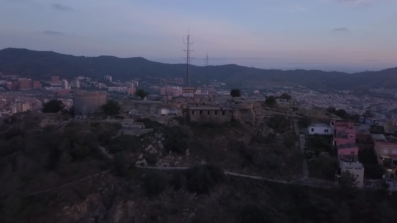 Ripresa aerea panoramica con drone che parte dai Bunkers fino al mare di Barcellona all'alba, Spagna