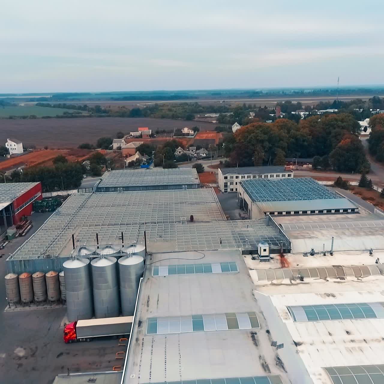 Abundant premises for storage construction materials. Big territory occupied by warehouses, cisterns and building items. Aerial view
