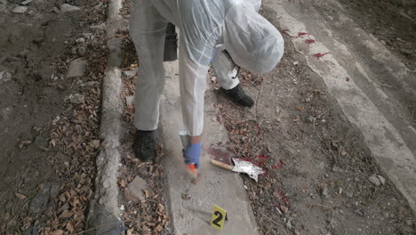 forensic specialist marks orange spray evidence crane shot