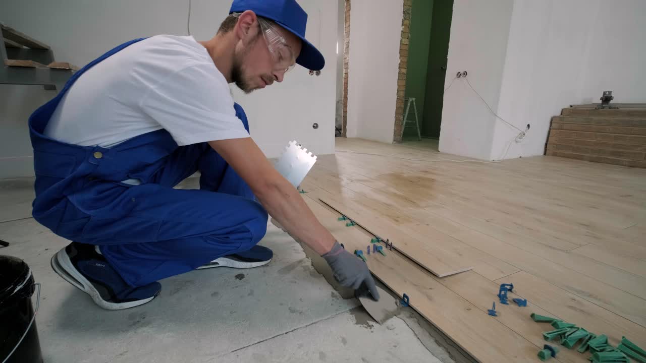 Installing ceramic floor tiles - measuring and cutting the pieces. Construction, renovation, repair apartment. Cuts tile. Tile cutting