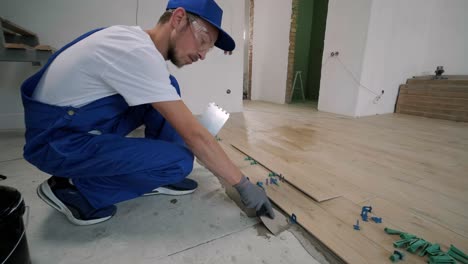 installing ceramic floor tiles - measuring and cutting the pieces. construction, renovation, repair apartment. cuts tile. tile cutting