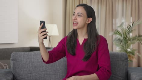 Happy-Indian-woman-talking-with-someone-on-video-call