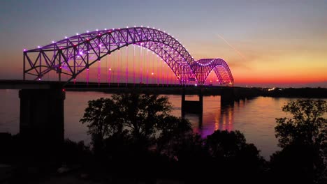 good rising evening night aerial of memphis hernando de soto bridge with colorful lights and mississippi river