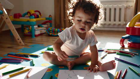 baby drawing with crayons