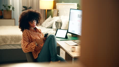 woman working from home on her phone and tablet