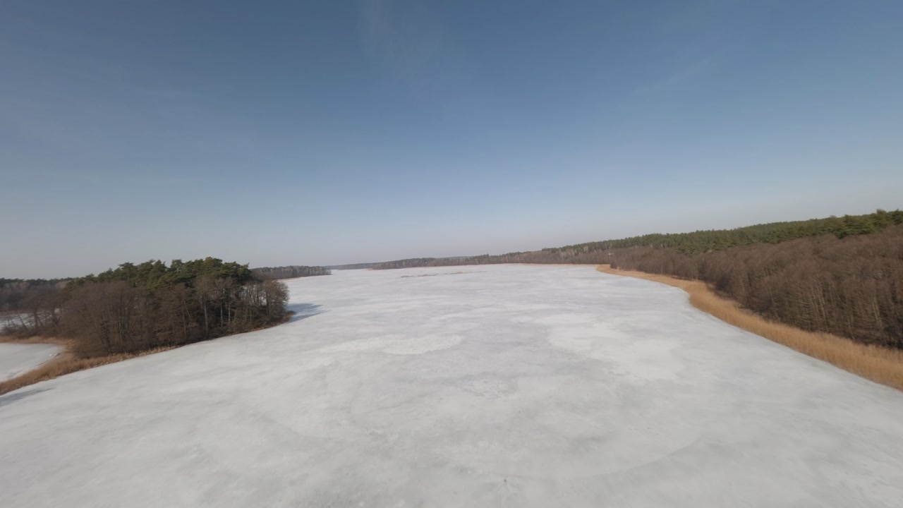 Cinematic FPV drone over frozen Masurian landscape