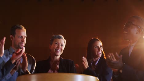 Colleagues-applauding-speaker-after-conference-presentation