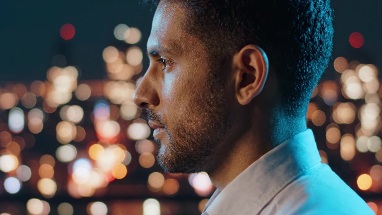 A Man Contemplating Life Against a Dazzling Cityscape at Night, Illuminated by Bright Lights and Urban Energy, Captured in Two Distinct Frames