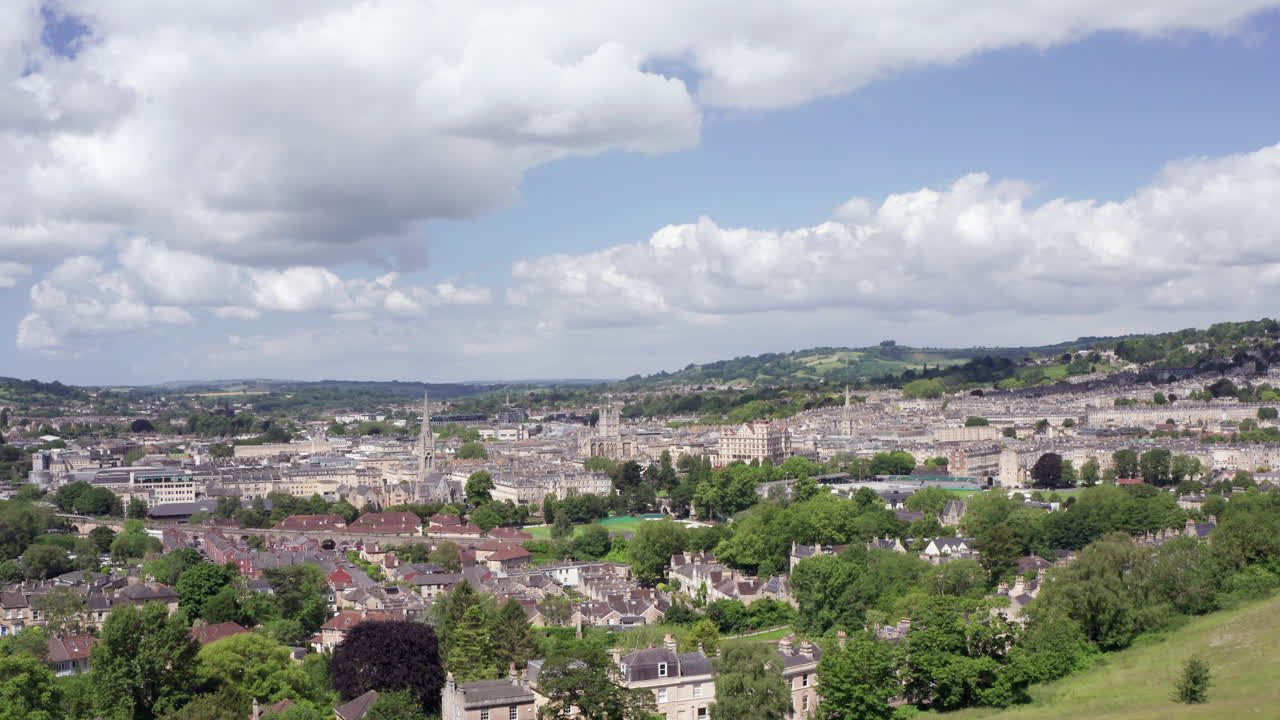 toma aérea alejándose de la ciudad de bath, incluida la abadía de bath, en el suroeste de inglaterra en un día soleado de verano