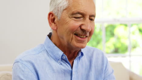 Senior-man-watching-his-tablet