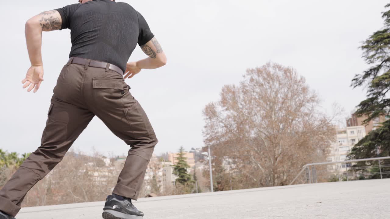 Breakdancer performing various moves in urban park