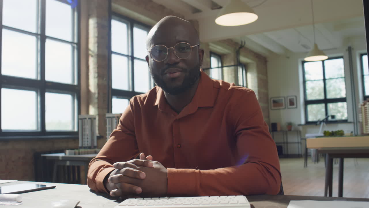 Professional Black Man on a Video Call in a Modern Office
