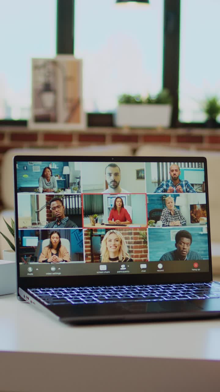 Vertical video Teleworker at home participating in internet videocall with colleagues,