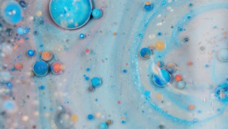 colorful liquid watercolor ink with glitter bubbles spinning around