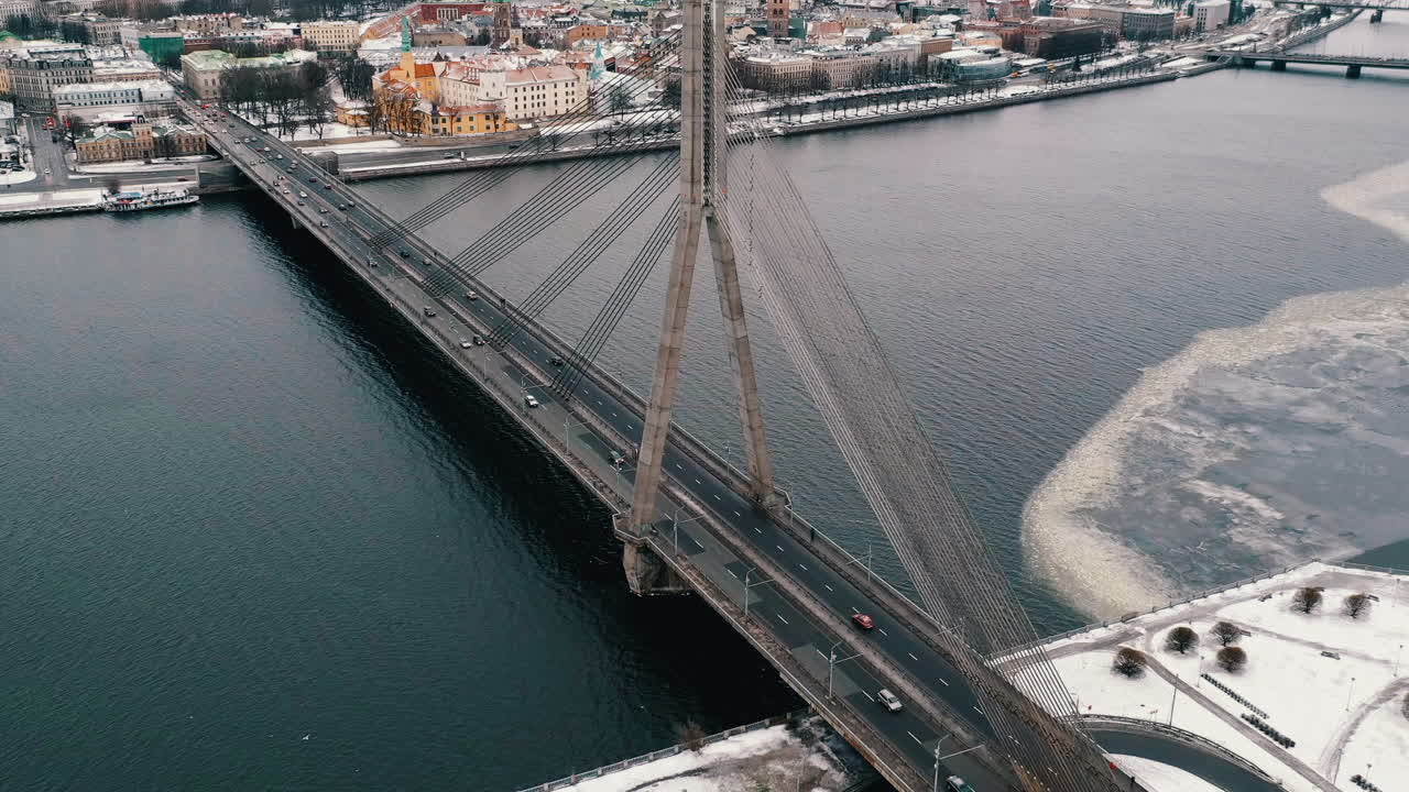 Aerial hyperlapse of Daugava river and traffic bridge in Riga