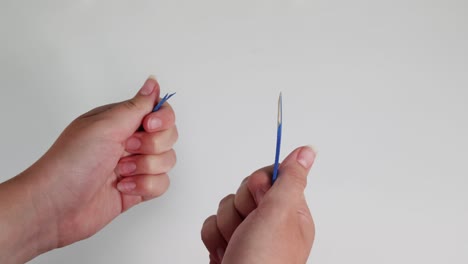 Two hands collaboratively snapping a pencil
