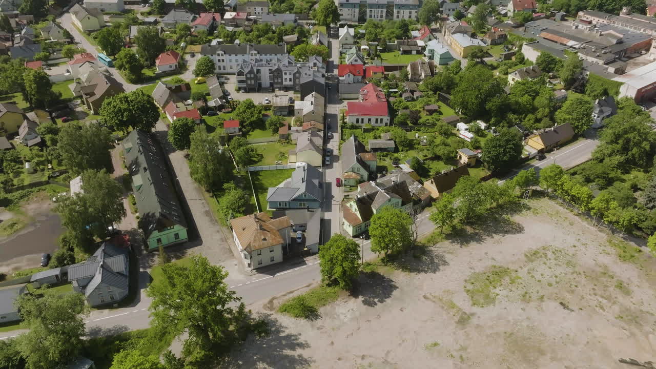 Aerial view tilting backwards over the suburbs of Parnu, summer day in Estonia
