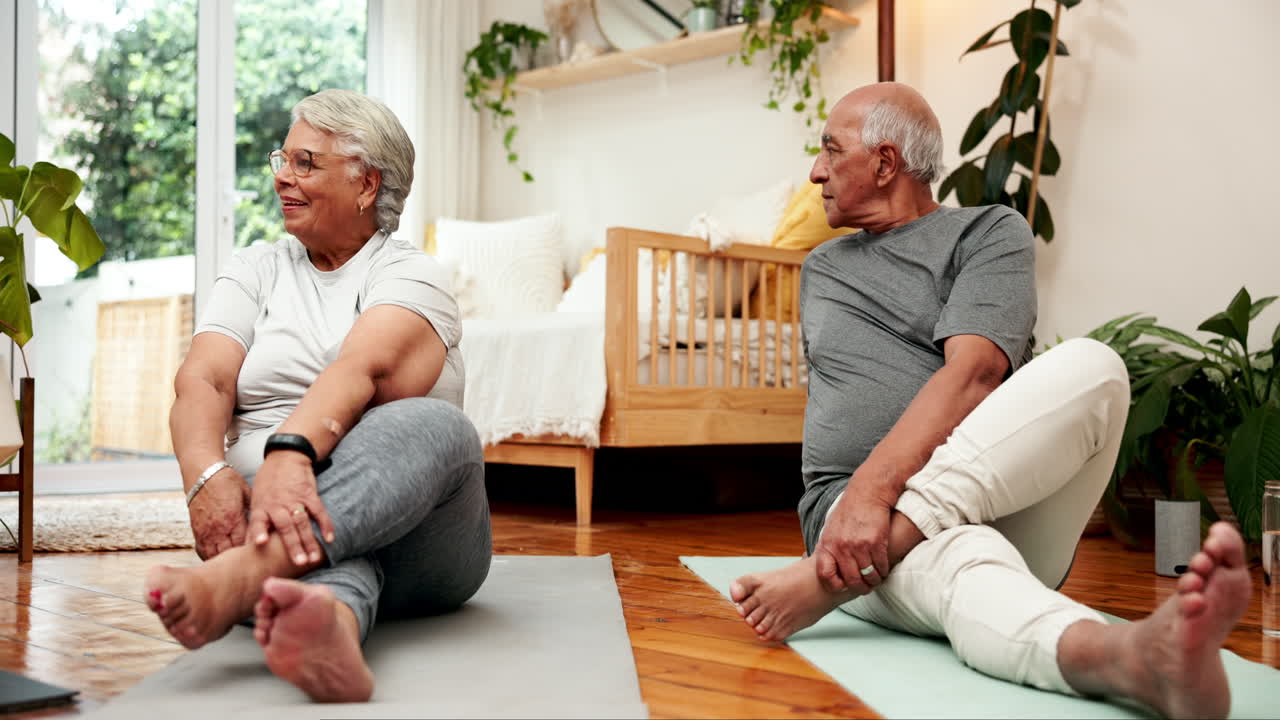Senior couple doing yoga at home