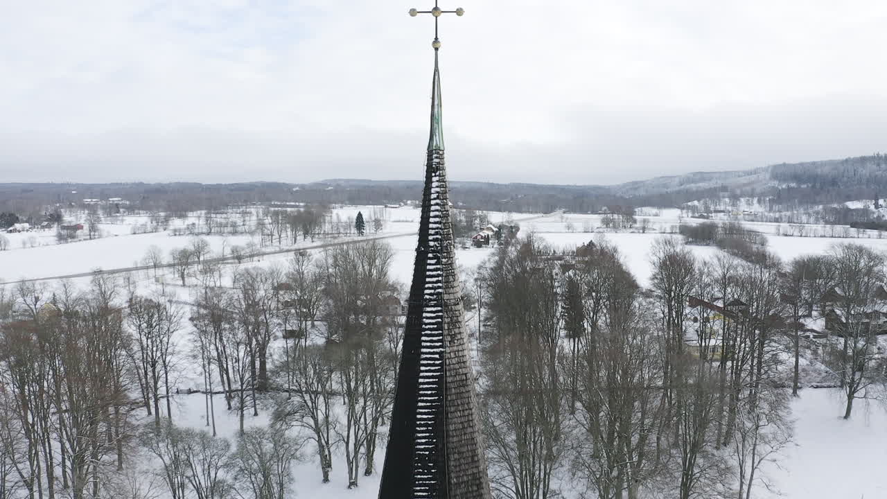 toma de primer plano de un dron de la campana y la torre de una iglesia en medio de los bosques de suecia