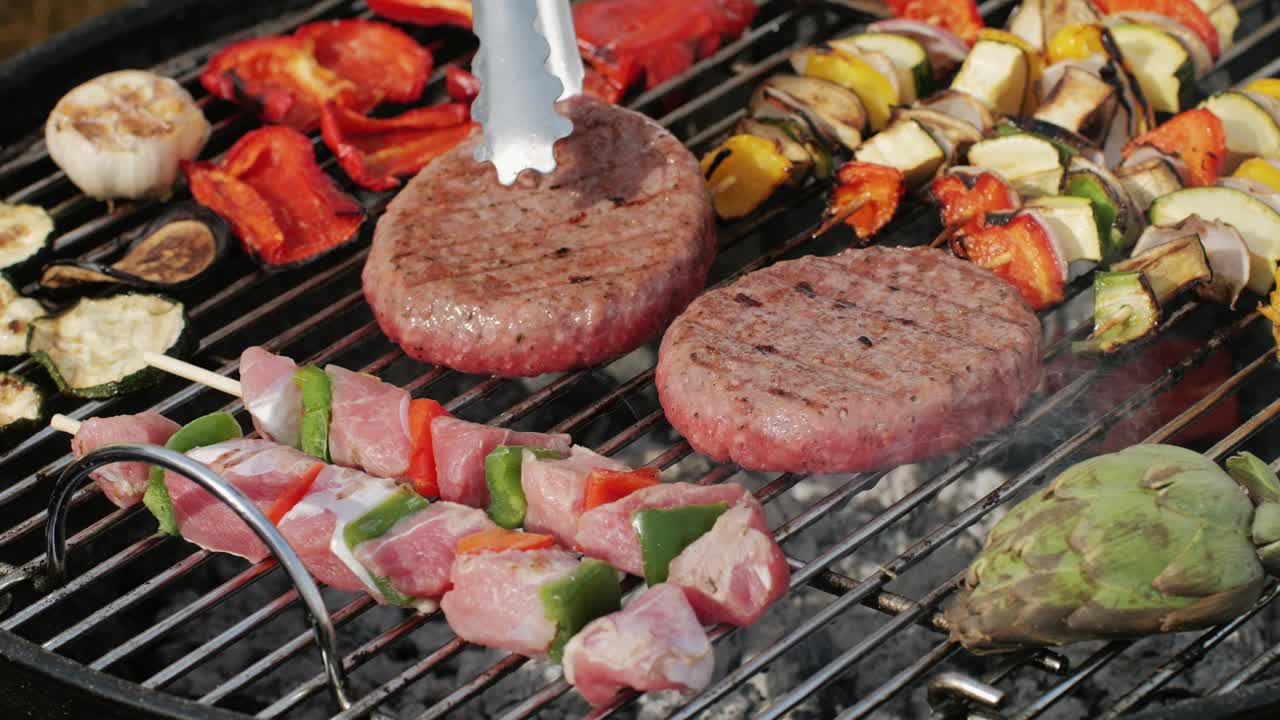 Traditional spanish barbeque, big sausage chorizo botifarra, pork and beef ribs on grill with fire, american style cooking, chef grilling meat fat food, steaks and sausages on bbq. High quality 4k footage
