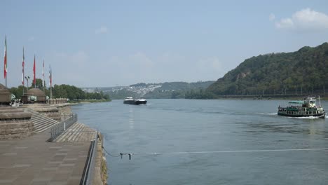 cargo ship on the rhine river at the deutsche eck in koblenz, germany