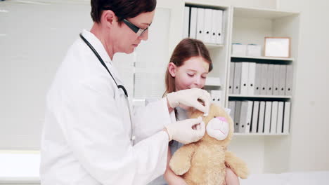 Doctor-examining-a-teddy-bear-