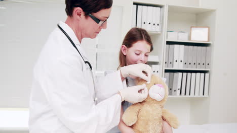 doctor examining a teddy bear
