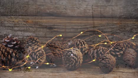 animation of pine cones christmas decoration over wooden surface