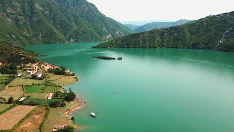 albania, emerald waters of lake koman amidst the accursed mountains, aerial view from a drone