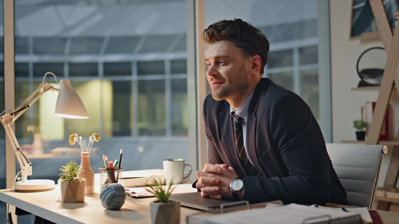 Smiling manager finish work on laptop at evening office closeup. Satisfied man