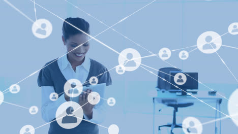 animation of network of profile icons against biracial woman using digital tablet at office