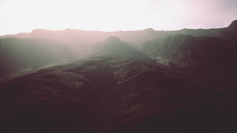 Dunkle-Atmosphärische-Landschaft-Mit-Hohem-Schwarzen-Berggipfel-Im-Nebel