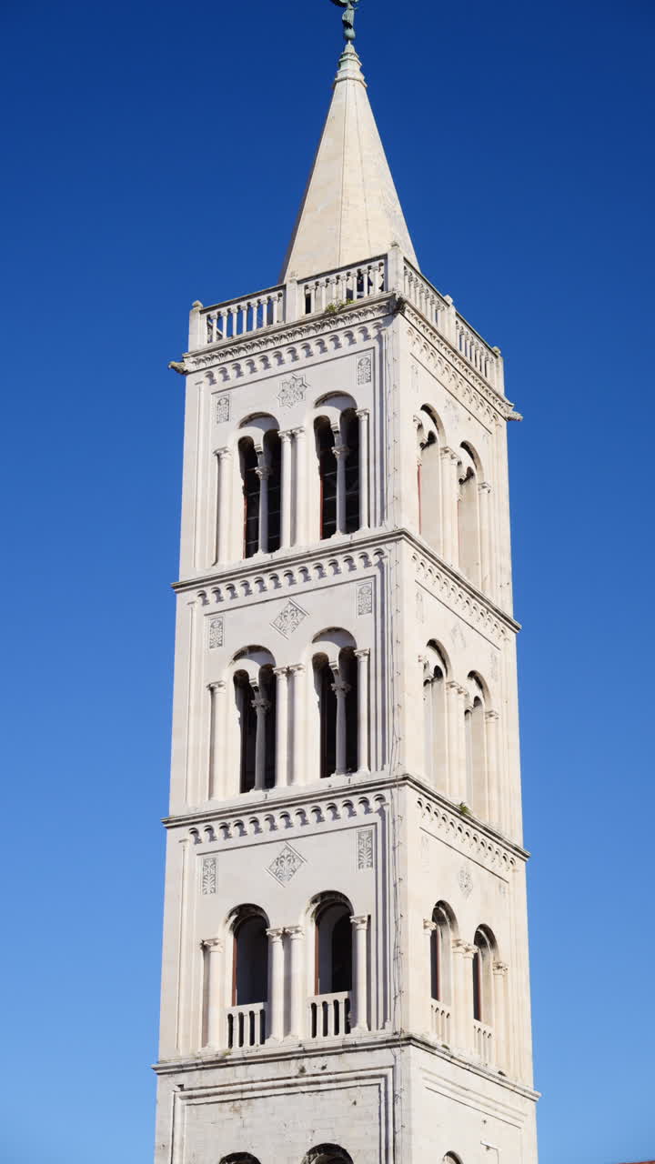 Romanesque bell tower of St. Anastasia's Cathedral in Zadar against a clear blue sky. Croatia