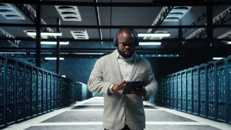 vertical video server room programmer wearing headphones troubleshooting errors