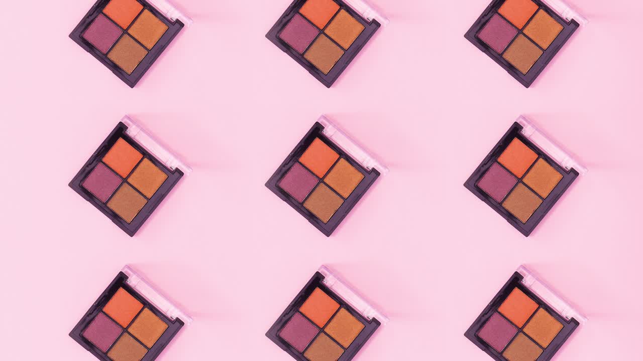 Creative pattern made of eye shadow palettes with four different colors rotating. Stop motion