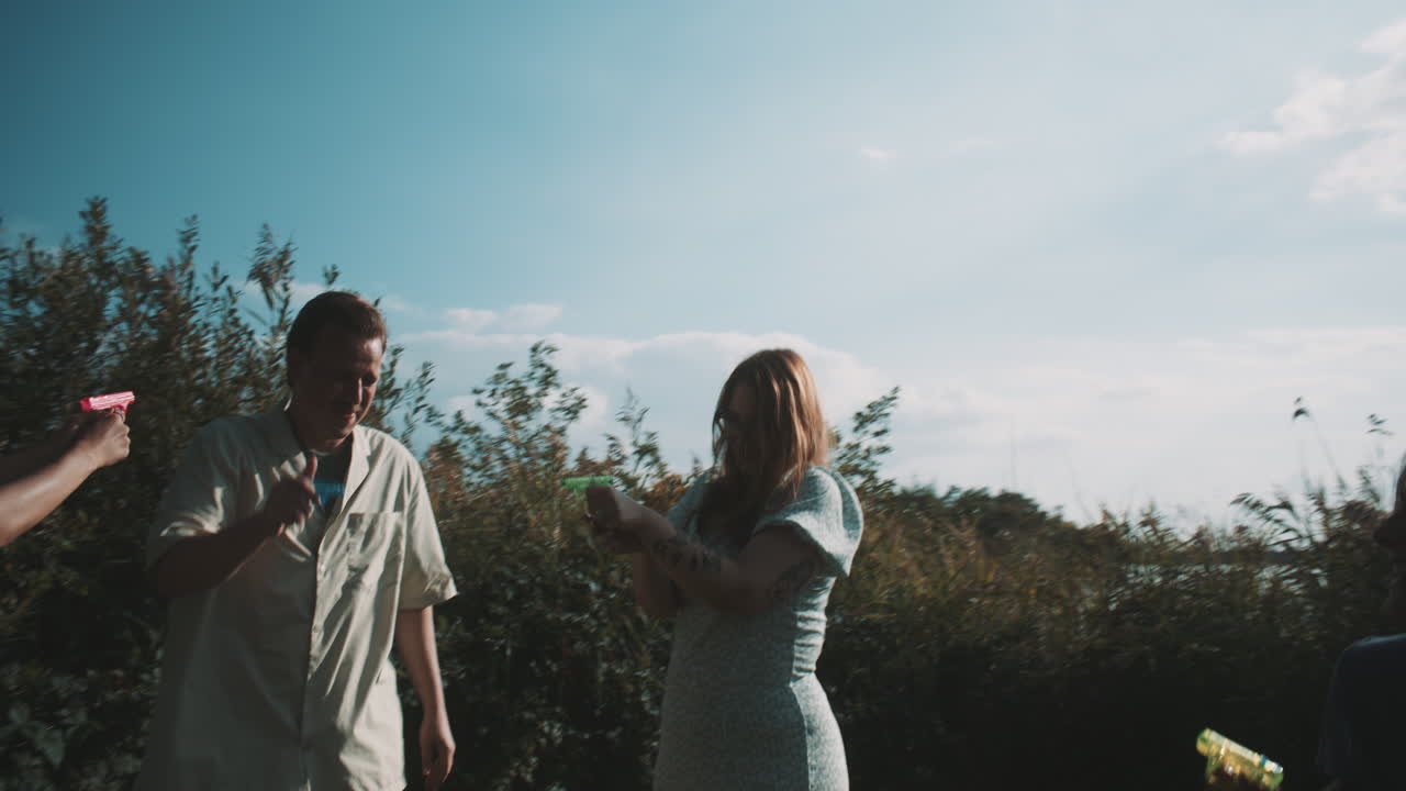 Friends Playing with Water Guns