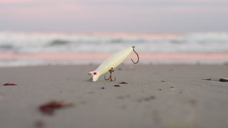 fishing lure washed up on the beach near the ocean