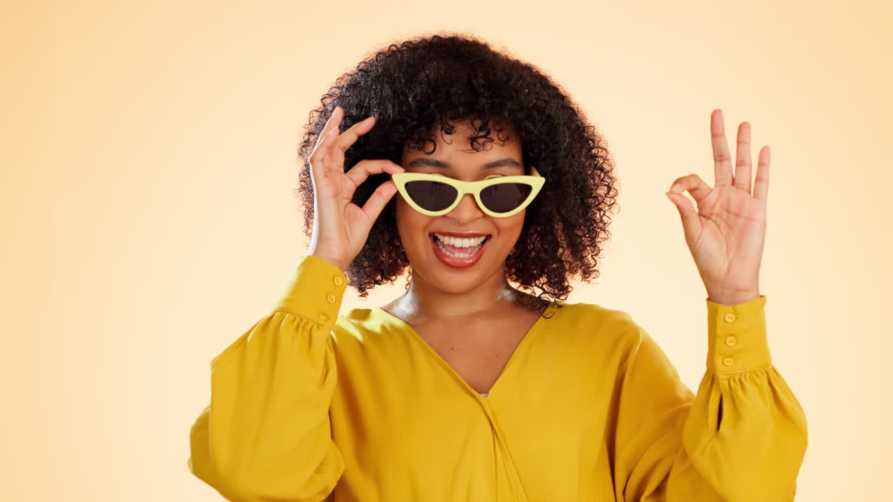 Wink, woman face and ok hand sign in studio