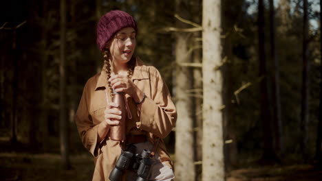 woman opening bottle standing in forest