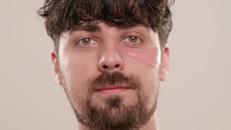 man applying eye patches