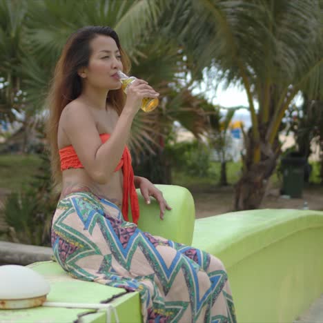 Lady-drinking-beer-in-tropical-park