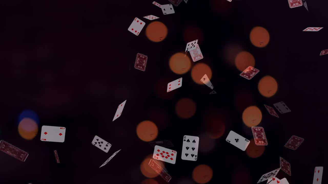 animación de luces bokeh sobre cartas de juego que caen sobre un fondo negro