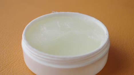 white jar of cream or ointment