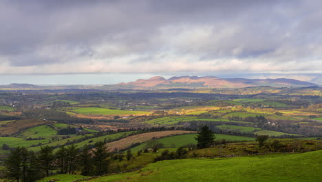 timelapse of rural nature farmland with hills in distance during sunny day viewed from carrowkeel in county sligo in ireland