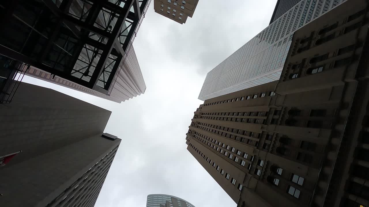 Upward view of Toronto's diverse skyscrapers on a cloudy day
